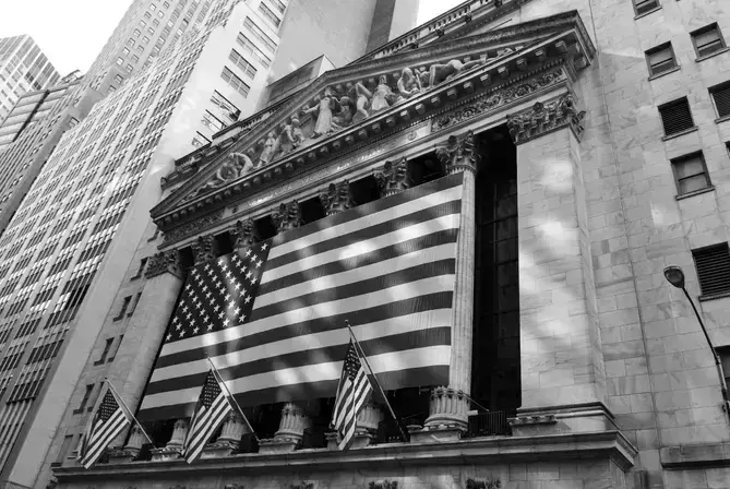 a photo of a building with a large american flag on it